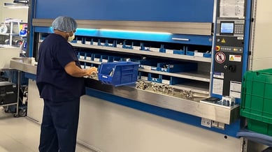 technician-sorting-sterile-instruments-in-automated-storage