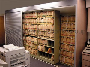 Store color coded medical files on open shelving behind rolling locking doors